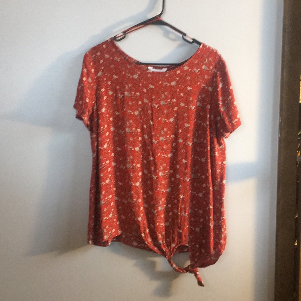 Burnt orange floral blouse.